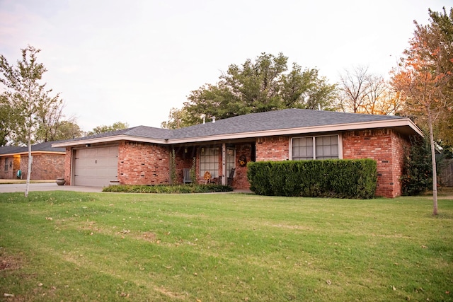 ranch-style home with a garage and a front yard