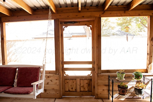 doorway featuring beam ceiling