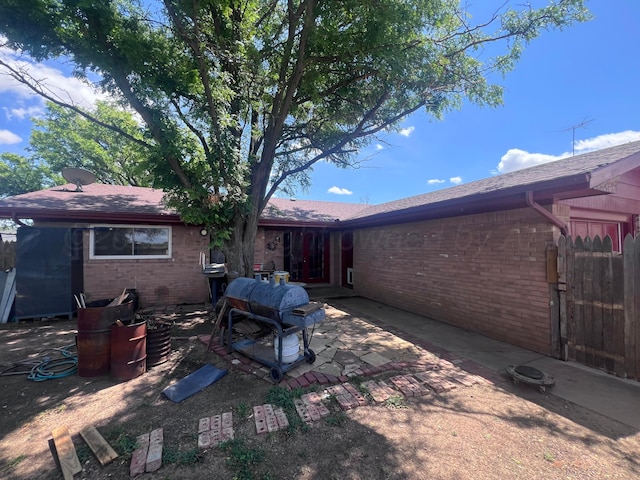 514 Willow Ln, Hereford, TX 79045 - back of property featuring brick siding, a patio area, and roof with shingles