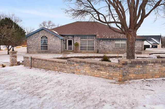 ranch-style house featuring brick siding