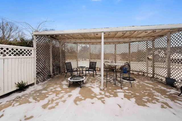 view of patio with an outdoor fire pit, outdoor dining area, fence, and a pergola