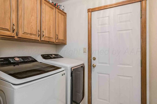 laundry room featuring cabinet space and separate washer and dryer