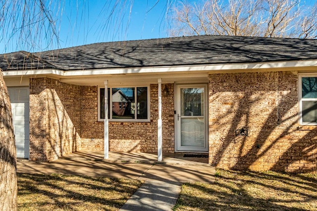 property entrance with a shingled roof