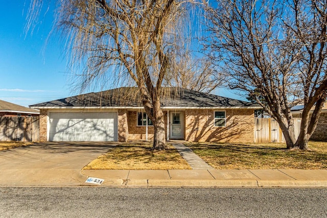 ranch-style home with driveway, brick siding, an attached garage, and fence