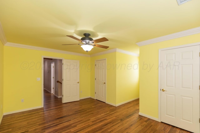 spare room with crown molding, baseboards, ceiling fan, and wood finished floors