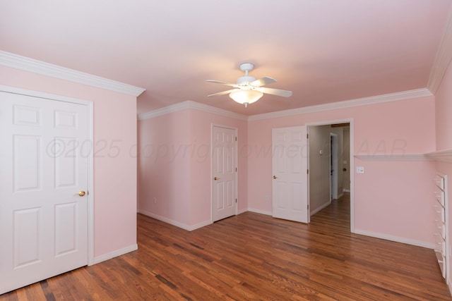 empty room featuring baseboards, crown molding, ceiling fan, and wood finished floors
