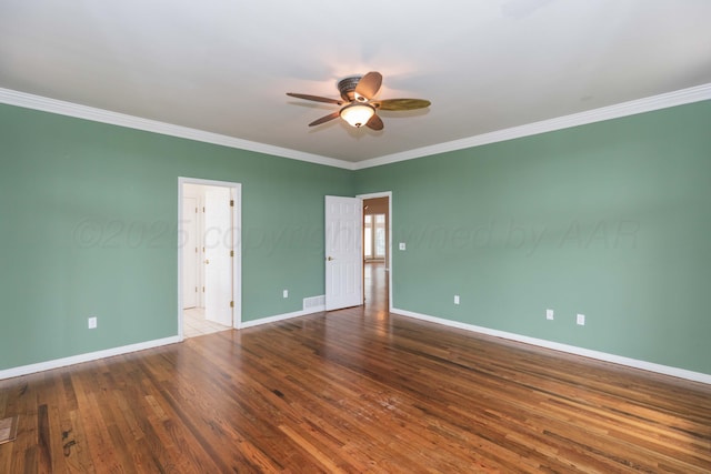 empty room with baseboards, ornamental molding, a ceiling fan, and wood finished floors