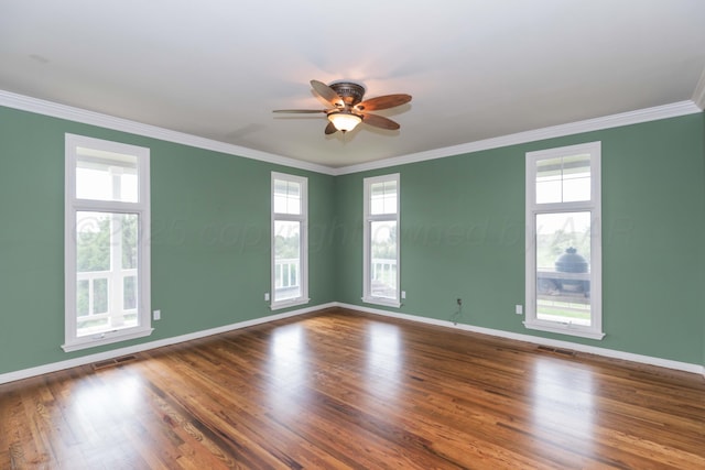 empty room featuring crown molding, a ceiling fan, visible vents, and plenty of natural light