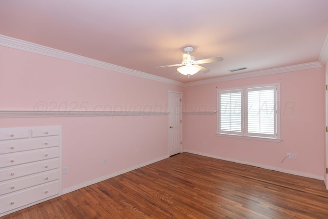 spare room with crown molding, ceiling fan, baseboards, wood finished floors, and visible vents