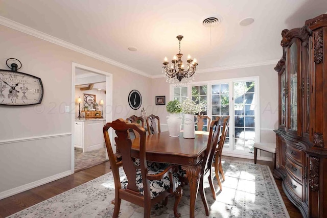 2200 Parker St, Amarillo, TX 79109 - dining room with a chandelier, wood finished floors, baseboards, and ornamental molding