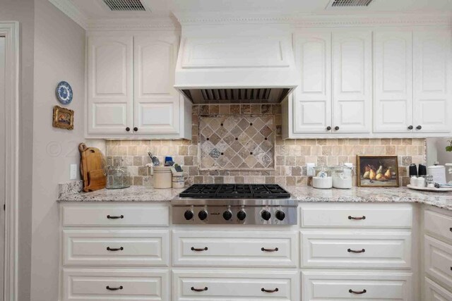 2200 Parker St, Amarillo, TX 79109 - kitchen featuring stainless steel gas stovetop, white cabinets, and decorative backsplash