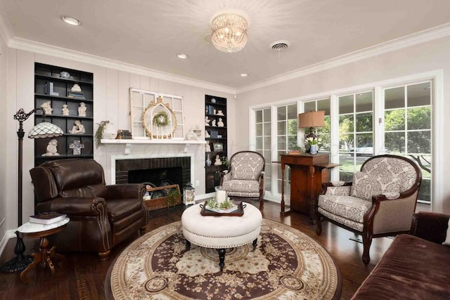 2200 Parker St, Amarillo, TX 79109 - living room featuring wood finished floors, crown molding, plenty of natural light, a brick fireplace, and built in features