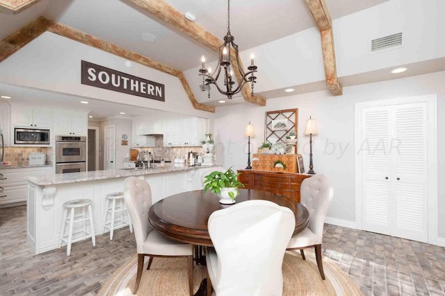 2200 Parker St, Amarillo, TX 79109 - dining space with a chandelier, beam ceiling, recessed lighting, baseboards, and high vaulted ceiling