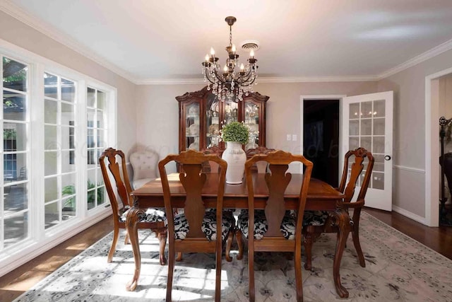 2200 Parker St, Amarillo, TX 79109 - dining space featuring a chandelier, crown molding, wood finished floors, and baseboards