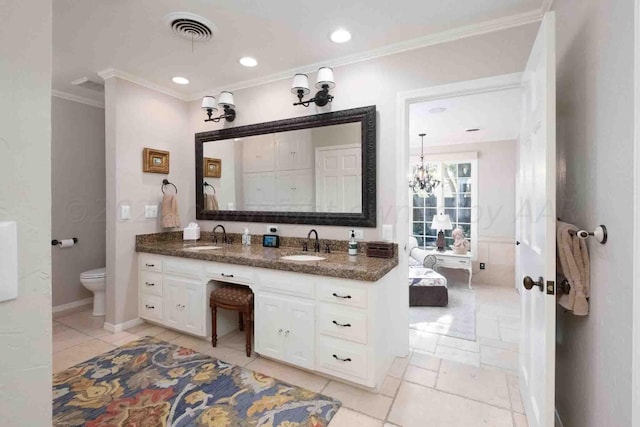 2200 Parker St, Amarillo, TX 79109 - bathroom with ornamental molding, toilet, double vanity, tile patterned flooring, and a chandelier