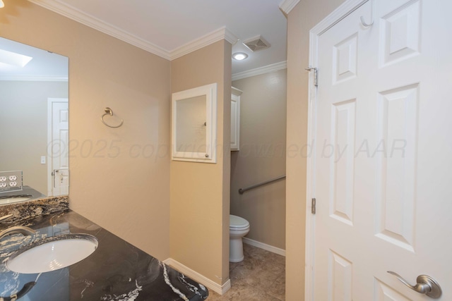 bathroom featuring crown molding, vanity, tile patterned floors, and toilet