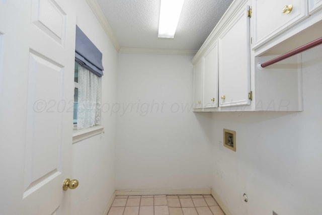 clothes washing area with cabinets, washer hookup, and a textured ceiling