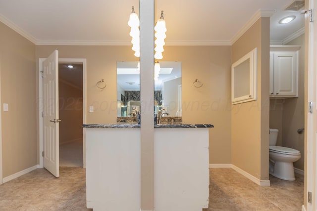 bathroom featuring ornamental molding, vanity, and toilet