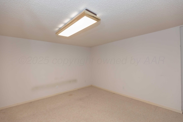 carpeted spare room featuring a textured ceiling