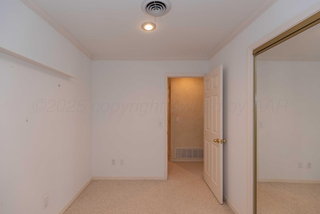 carpeted spare room featuring crown molding