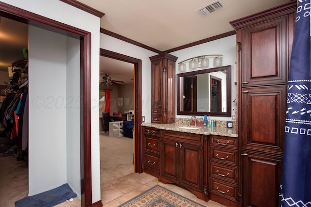 2900 Teckla Blvd, Amarillo, TX 79106 - bathroom with vanity, tile patterned flooring, a walk in closet, crown molding, and a ceiling fan