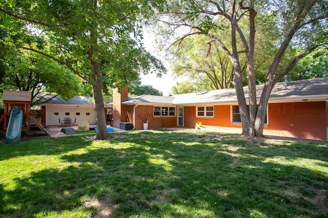2900 Teckla Blvd, Amarillo, TX 79106 - back of property with a chimney, brick siding, a patio area, and a yard