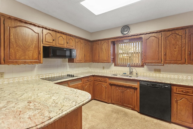 kitchen featuring tasteful backsplash, sink, and black appliances