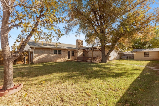 rear view of property with a yard