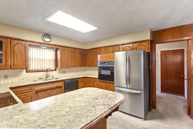 kitchen featuring backsplash, light carpet, black appliances, sink, and a textured ceiling