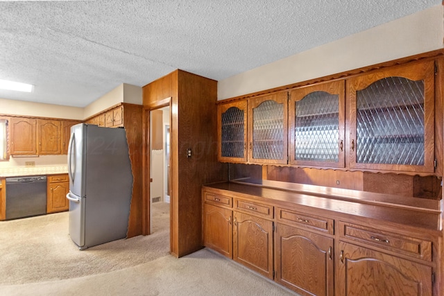 kitchen featuring stainless steel fridge, black dishwasher, light colored carpet, and a textured ceiling