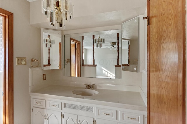 bathroom featuring a textured ceiling, vanity, and ceiling fan