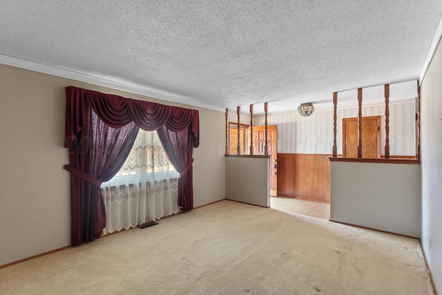 empty room with a textured ceiling and light carpet