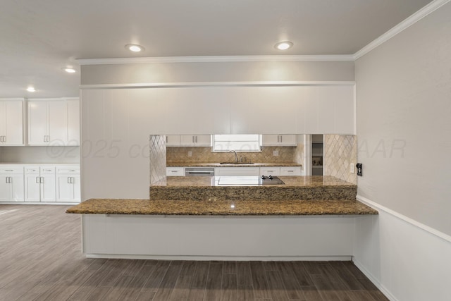 3506 Barclay Dr, Amarillo, TX 79109 - kitchen with white cabinets, ornamental molding, decorative backsplash, dark stone countertops, and dark wood-style floors