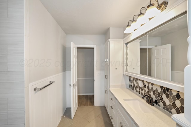 3506 Barclay Dr, Amarillo, TX 79109 - bathroom with vanity, wainscoting, backsplash, and tile patterned floors