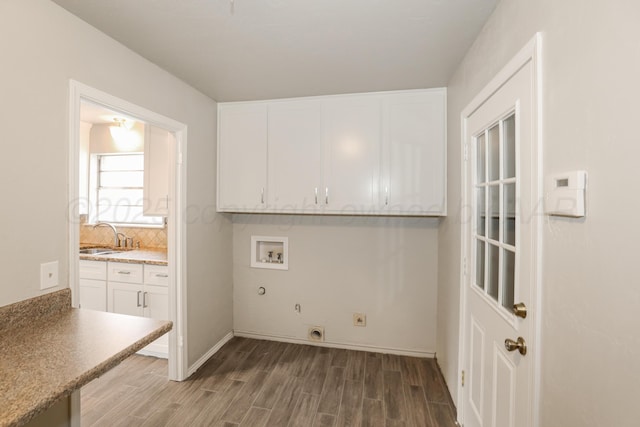 3506 Barclay Dr, Amarillo, TX 79109 - laundry area with cabinet space, electric dryer hookup, wood finished floors, hookup for a washing machine, and gas dryer hookup