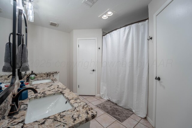 6211 Edgeware Pl, Amarillo, TX 79109 - bathroom featuring tile patterned flooring, double vanity, and curtained shower