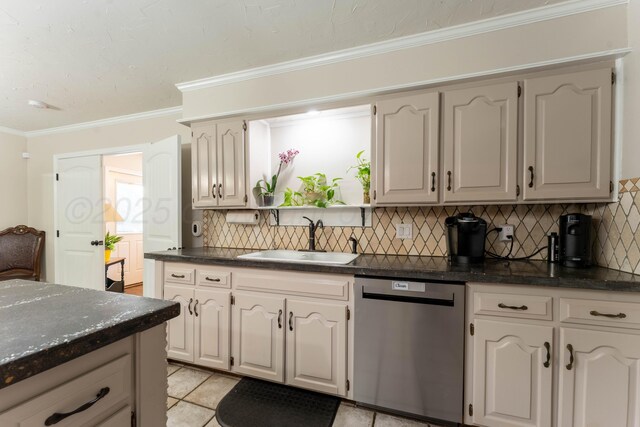 6211 Edgeware Pl, Amarillo, TX 79109 - kitchen with stainless steel dishwasher, tasteful backsplash, ornamental molding, light tile patterned floors, and dark stone counters