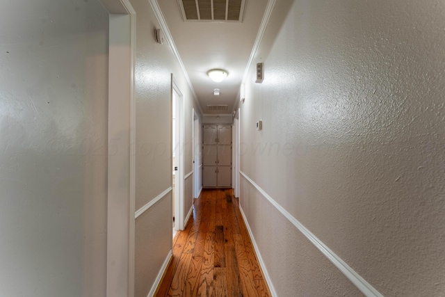6211 Edgeware Pl, Amarillo, TX 79109 - corridor with light wood-style flooring, attic access, and a textured wall