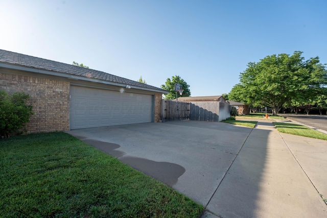 6211 Edgeware Pl, Amarillo, TX 79109 - view of side of home featuring a garage, brick siding, and driveway