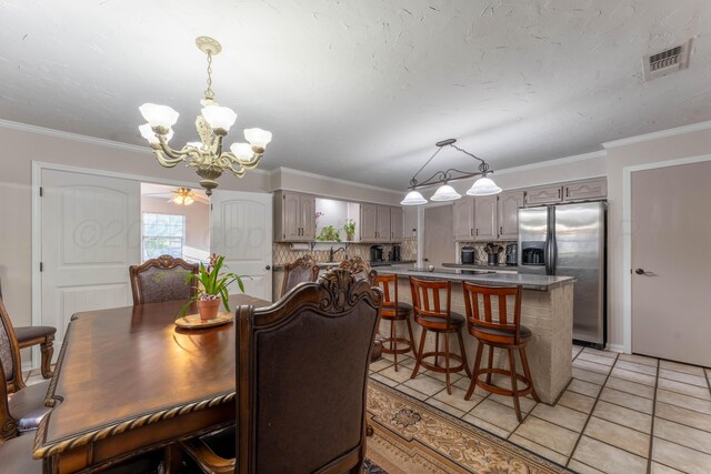 6211 Edgeware Pl, Amarillo, TX 79109 - dining space featuring a chandelier, ornamental molding, light tile patterned floors, and ceiling fan