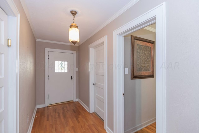 entryway featuring wood-type flooring and ornamental molding