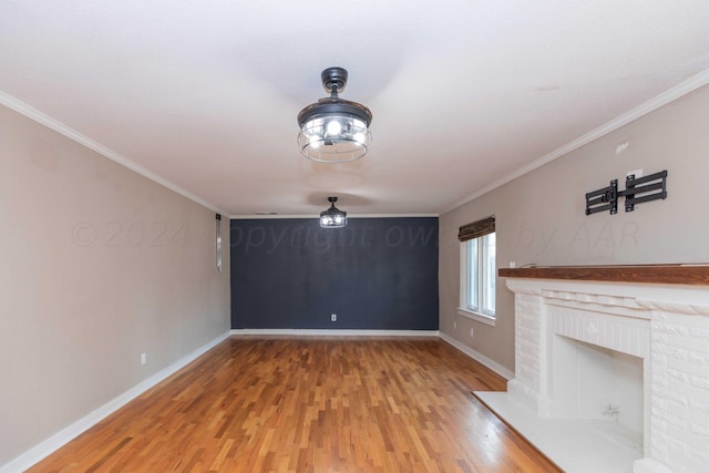 unfurnished living room featuring a fireplace, wood-type flooring, and ornamental molding