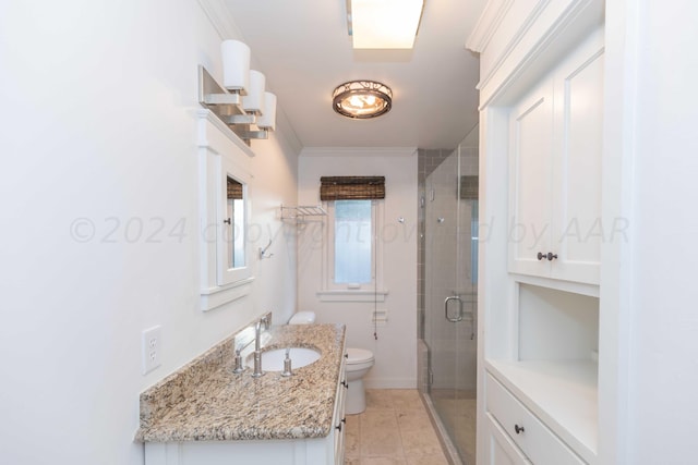 bathroom featuring ornamental molding, vanity, a shower with shower door, and toilet