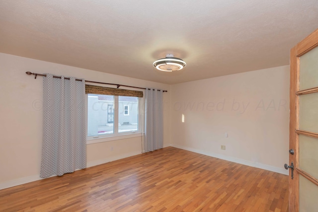 empty room with wood-type flooring