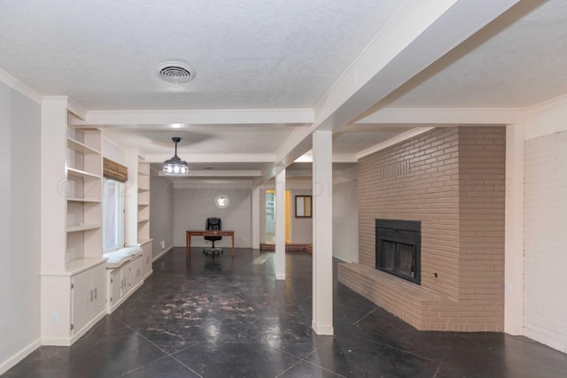 living room with brick wall, built in shelves, a textured ceiling, beam ceiling, and a fireplace