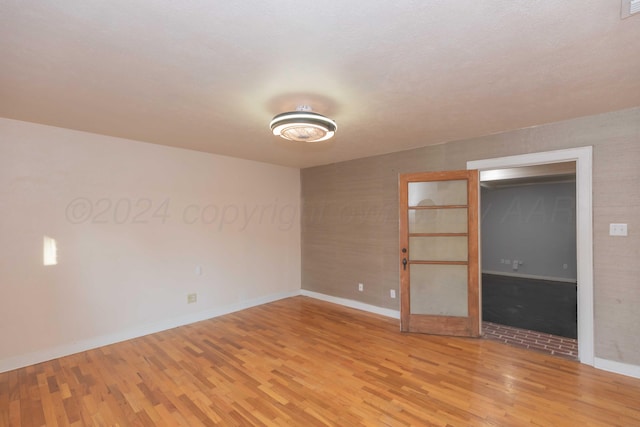 spare room with light hardwood / wood-style floors