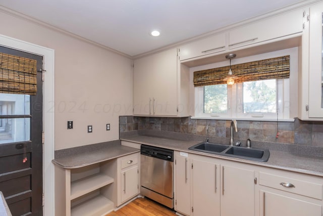 kitchen featuring backsplash, white cabinets, sink, stainless steel dishwasher, and decorative light fixtures