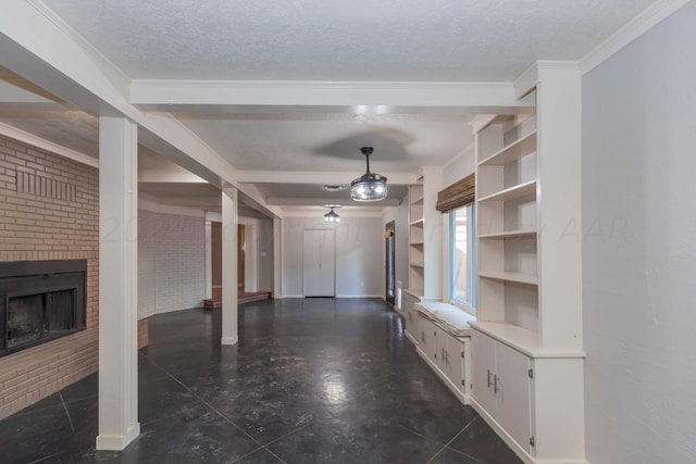 unfurnished living room with a fireplace, built in shelves, a textured ceiling, and ornamental molding