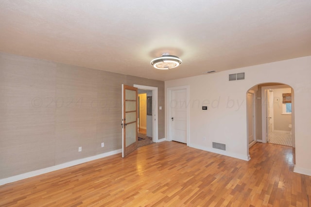 spare room with light hardwood / wood-style flooring