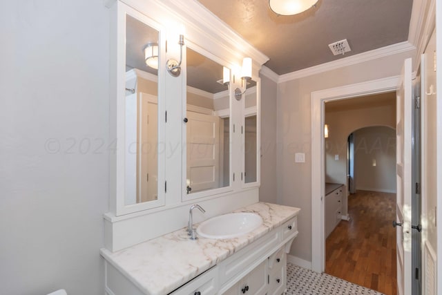 bathroom featuring vanity and ornamental molding